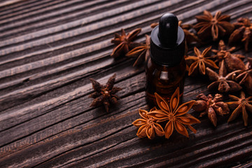 essential oil of the anise stars on a dark rustic background