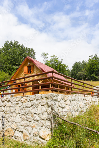 Mountain Cottage With Stone Retaining Wall Stock Photo And