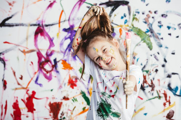 Obraz na płótnie Canvas Dirty girl with painting brush grabbing her hair