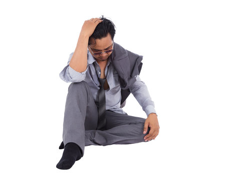 stressed businessman touching his head and thinking isolated on white