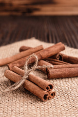 Cinnamon essential oil on a wooden background