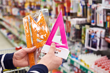 Buyer selects plastic rulers and in store