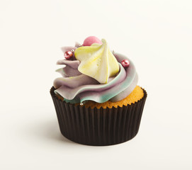 Tasty muffin with buttercream isolated on white