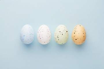 Easter eggs selection on a pastel blue background viewed from above. Top view. Copy space