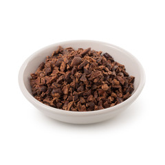 Bowl of cacao nibs isolated on a white background