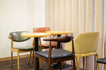 Colorful leather chair and brown wooden table set for breakfast, lunch and dinner - interior concept.