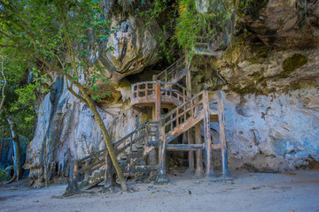 Fototapeta na wymiar Outdoor view of stoned stairs at the enter of ancient cave Khao khanabnam in Krabi province, Thailand