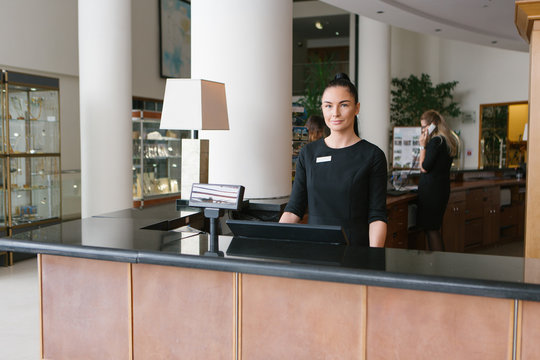 Pretty hotel worker working in reception