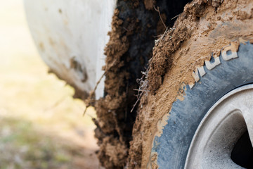 Dirty wheel closeup and the inscription mud on the tires