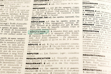 Close up of french dictionary page with word reputation