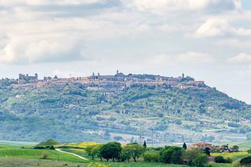 Fototapeta na wymiar View towards the village of Montalcino on a hill in Italy