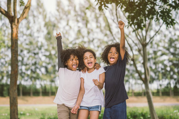 Happy African american little boy kid children joyfully cheerful and laughing. Concept of happiness, gladness and fun.
