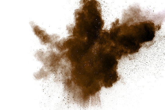Freeze motion of brown dust explosion. Stopping the movement of brown powder. Explosive brown powder on white background. Dry soil splater on white background.