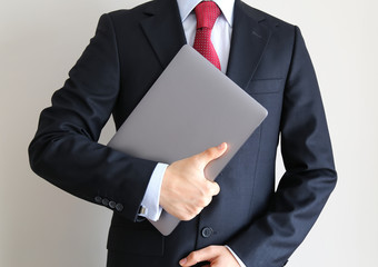 smart business man hold labtop to do his work , businessman on the white background