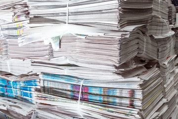 a lot of newspapers lie on the heap in the printing center