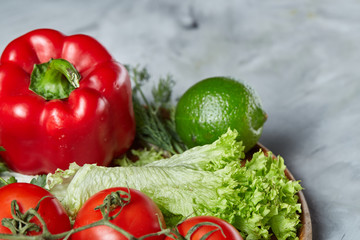 Delicious composition of assorted fresh vegetables and herbs on white textured background, top view, selective focus.