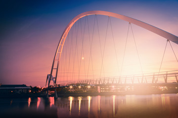 Fototapeta na wymiar Infinity Bridge on dramatic sky at sunset in Stockton-on-Tees, UK.