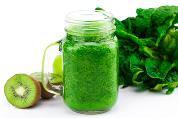 Healthy green smoothie with spinach and kiwi in a jar mug isolated on white