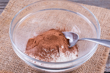 Cocoa and flour in a glass bowl on a table