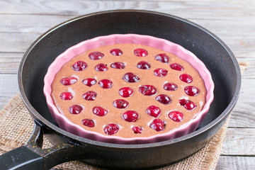Chocolate dough with cherry in ceramic form