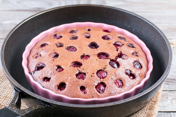 Chocolate dough with cherry in ceramic form