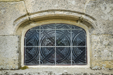 Very decorative small window with floral and geometric pattern
