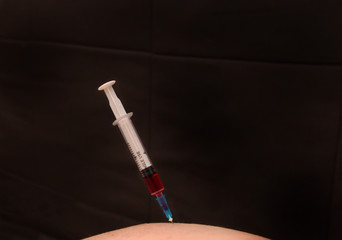 The syringe with the medicine in the body