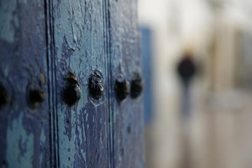 A blue door with nails in the city of Essaouira , Morroco