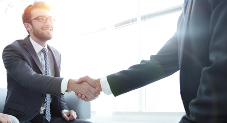 handshake business partners in the office
