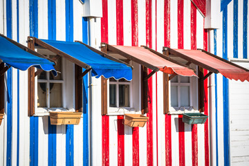 Colorful striped fishermen's houses in blue and red, Costa Nova, Aveiro, Portugal