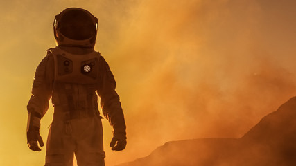 Brave Astronaut Confidently Walks on Mars Surface. Red Planet Covered in Gas and rock,  Overcoming Difficulties, Important Moment for the Human Race.