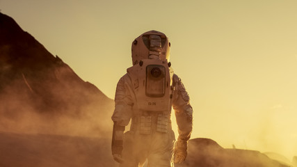 Shot of Astronaut Confidently Walking on Mars. Red Planet Covered in Gas and Smoke. Humans...