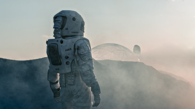 Shot of the Astronaut on Red Planet Watching Toward His Base/Research Station. Near Future First Manned Mission To Mars, Technological Advance Brings Space Exploration, Colonization.