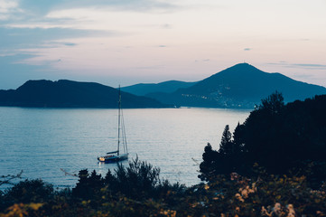 Sailing yacht at twilight in the bay . Adriatic Sea, Montenegro, Sveti Stefan