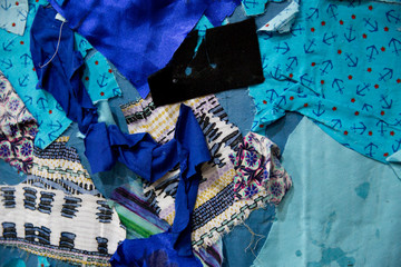 Concept: Do it yourself homemade bed cover. Abstract texture background made of fabric pieces. Pieces of blue coloured fabric. Patchwork.