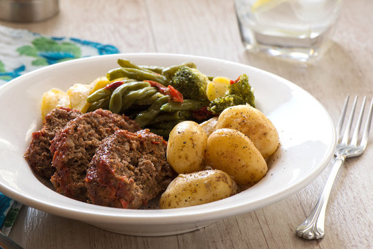 Meal with meatloaf, new potatoes and vegetables