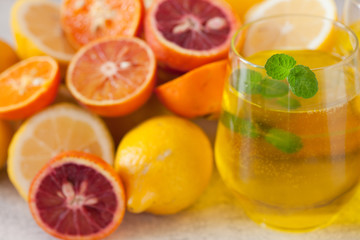 Fototapeta na wymiar Detox citrus water, refreshing summer homemade lemonade cocktail with lemon and orange