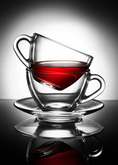transparent Cup of tea in a Cup on a saucer on the gradient background