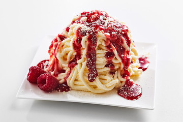 Spaghetti ice cream dessert with sweet red topping