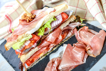 sandwiches with salad, tomatoes, ham and onions