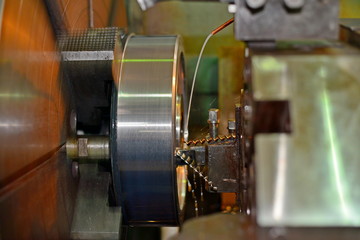 The metal part is machined on a lathe