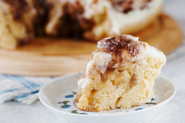 Homemade cinnamon roll with cream sauce on the plate