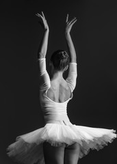 Fototapeta premium Young beautiful ballerina is posing in studio
