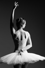 Fototapeta premium Young beautiful ballerina is posing in studio