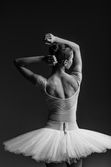 Fototapeta premium Young beautiful ballerina is posing in studio