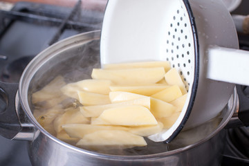 Cut potatoes in a saucepan with starting water to boil.