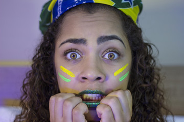 Supporter of Brazil watch on television a tense football game © Nexa