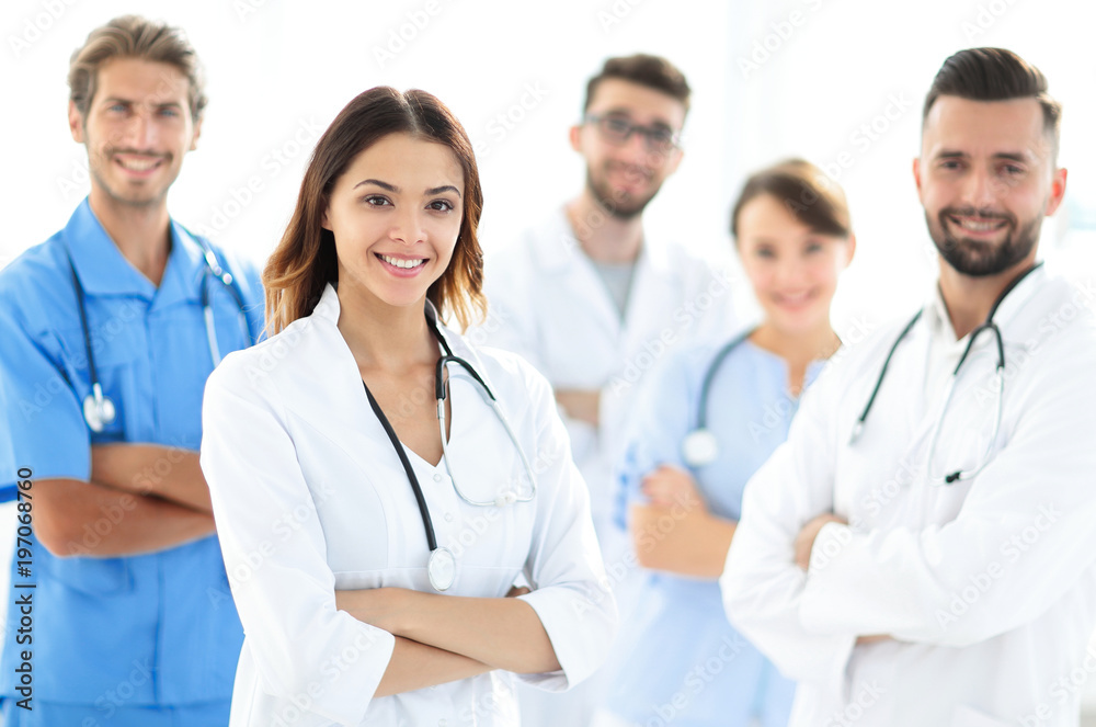 Wall mural attractive female doctor with medical stethoscope in front of medical group