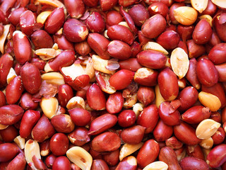 Peanut background. Dry-roasted peanuts kernel, halves, peeled nuts. Close-up. Top view. Harvest of groundnut and the goober, arachis hypogaea