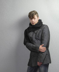 portrait of a teenage boy in a coat and scarf